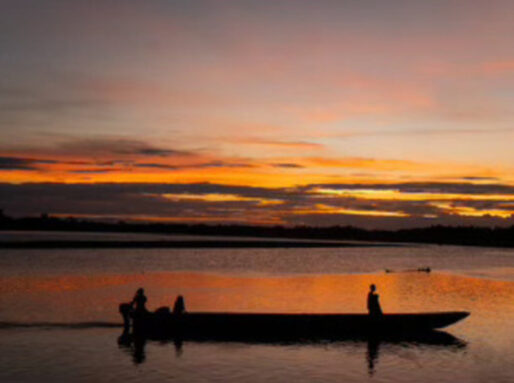 A fishermen boat past by the port during sunset at Curillo, Caqueta, Colombia, on the Caqueta river.